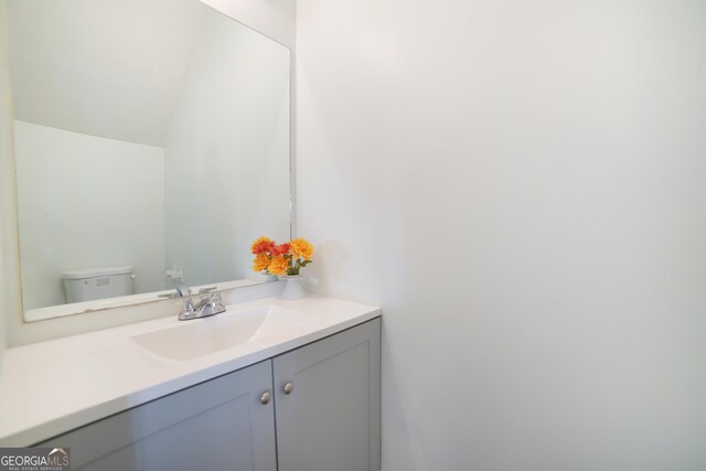 bedroom with hardwood / wood-style floors, a skylight, and connected bathroom