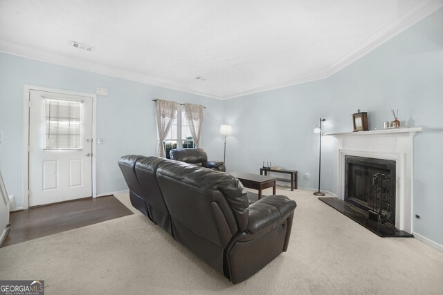 carpeted living room with ornamental molding