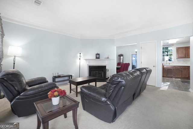 carpeted living room featuring ornamental molding