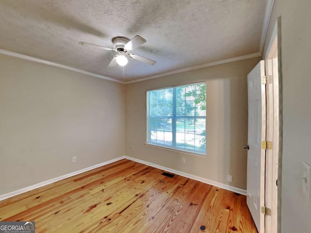 empty room featuring a textured ceiling, ceiling fan, ornamental molding, and light hardwood / wood-style flooring