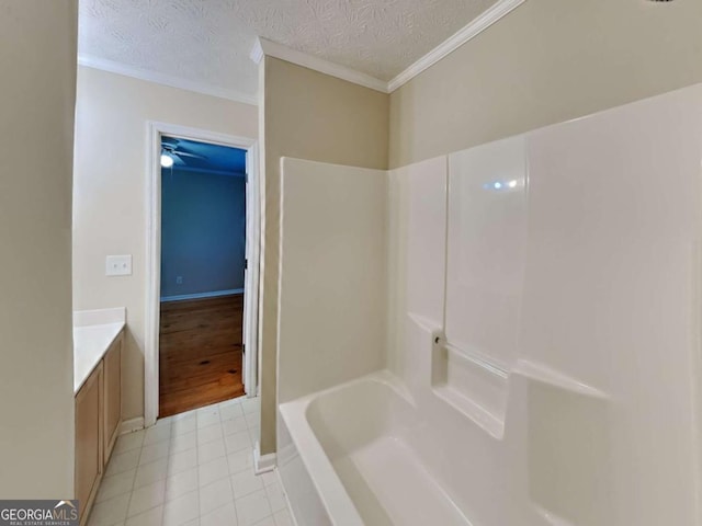 bathroom featuring bathtub / shower combination, a textured ceiling, vanity, and crown molding