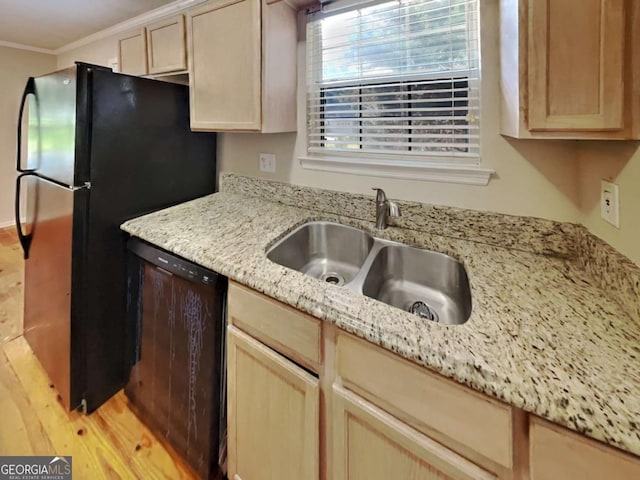 kitchen featuring light brown cabinets, light stone countertops, ornamental molding, black appliances, and sink