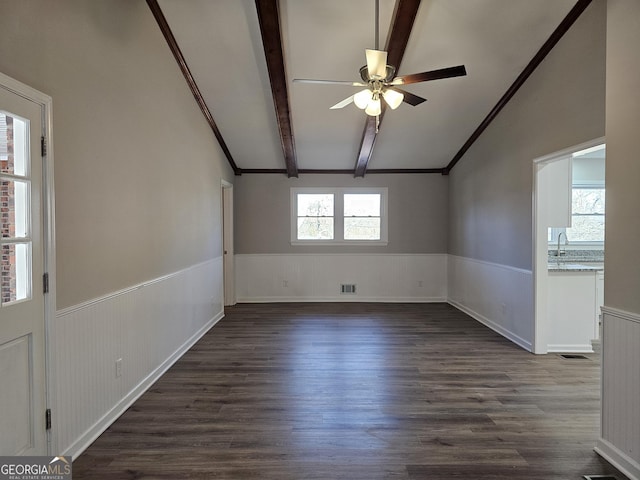 empty room with dark hardwood / wood-style flooring, vaulted ceiling with beams, and sink