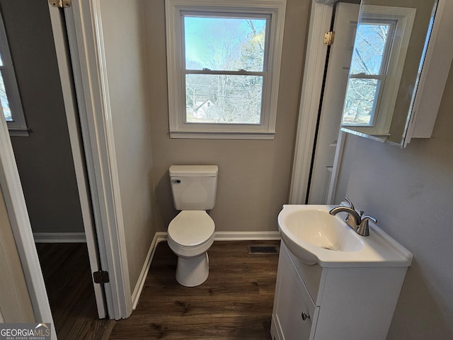 bathroom featuring toilet, vanity, and hardwood / wood-style flooring