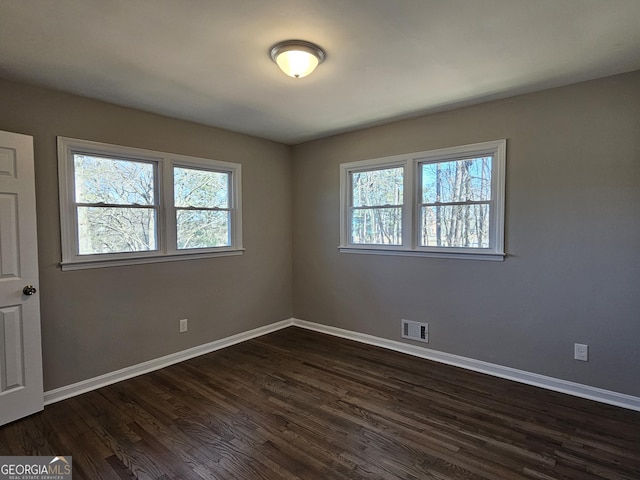 unfurnished room featuring dark wood-type flooring