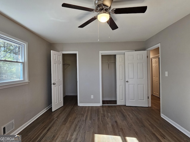 unfurnished bedroom featuring ceiling fan and dark wood-type flooring