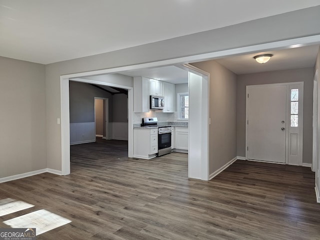 foyer featuring a healthy amount of sunlight and dark hardwood / wood-style floors