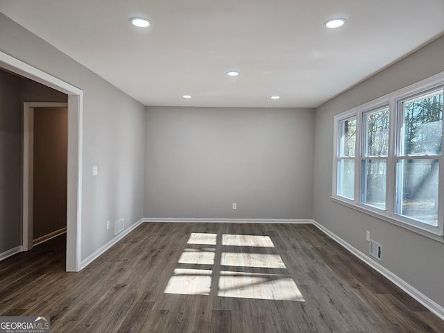 spare room featuring dark hardwood / wood-style flooring