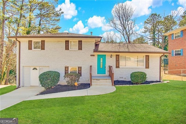 split level home featuring a garage and a front yard