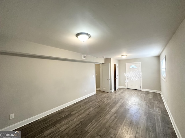 unfurnished room featuring dark hardwood / wood-style flooring