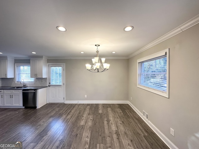 kitchen with backsplash, dark hardwood / wood-style floors, dishwashing machine, sink, and white cabinets