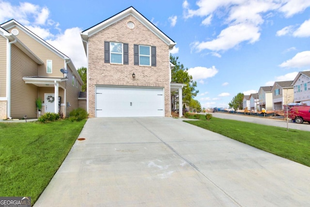 view of property featuring a front yard and a garage