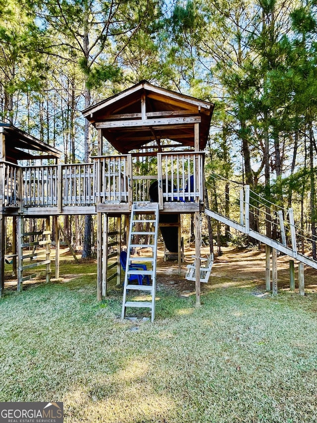 view of jungle gym featuring a lawn