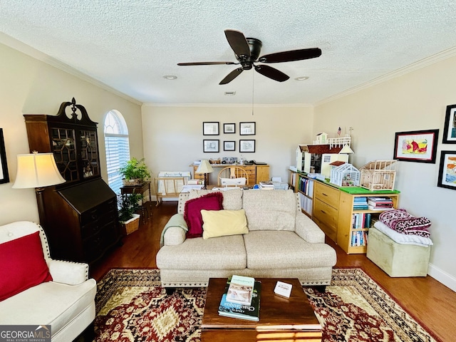 living room with dark wood-type flooring, a textured ceiling, and ornamental molding