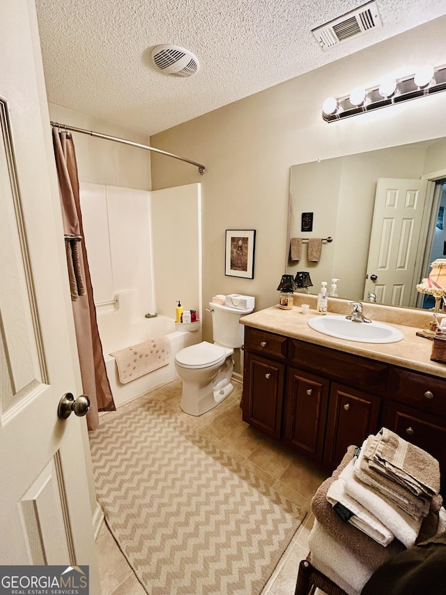 full bathroom with toilet, shower / bath combination with curtain, tile patterned floors, a textured ceiling, and vanity