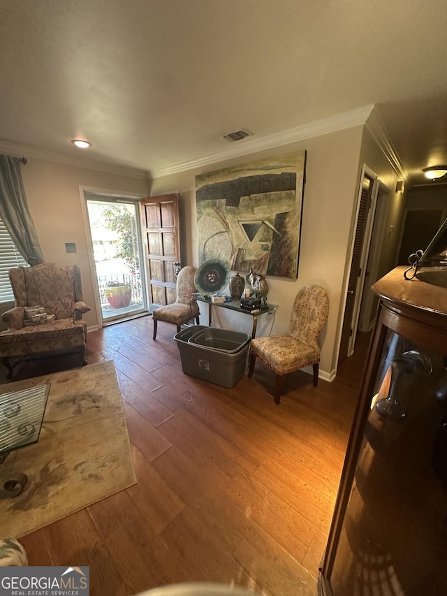 living room featuring crown molding and wood-type flooring