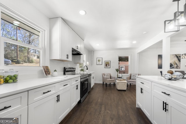 kitchen with dark wood-type flooring, sink, white cabinetry, stainless steel electric range, and pendant lighting