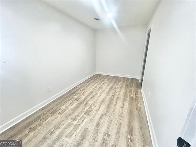 spare room featuring light hardwood / wood-style flooring