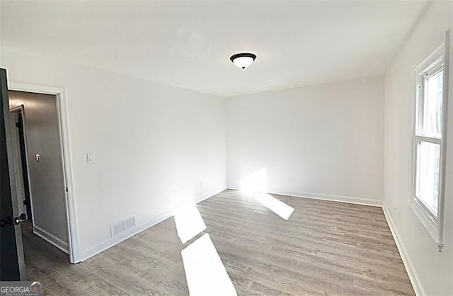 empty room with light hardwood / wood-style floors