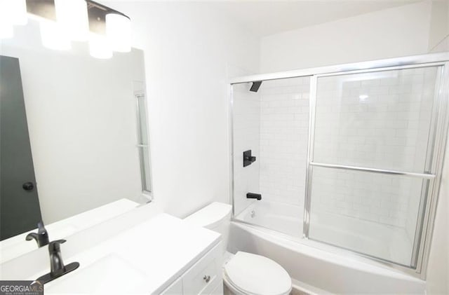 full bathroom with toilet, bath / shower combo with glass door, and vanity