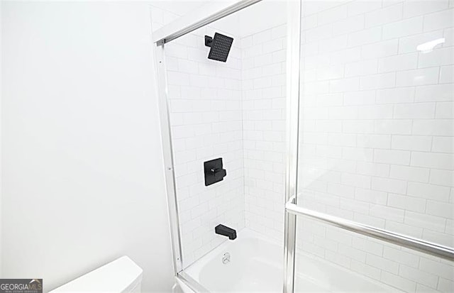 bathroom featuring shower / bath combination with glass door