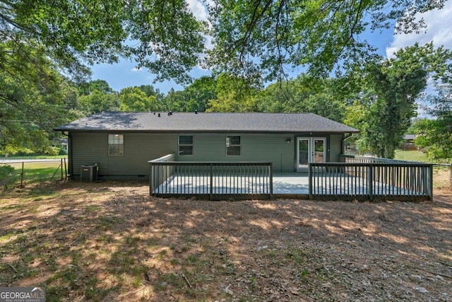 rear view of house featuring central AC unit and a deck