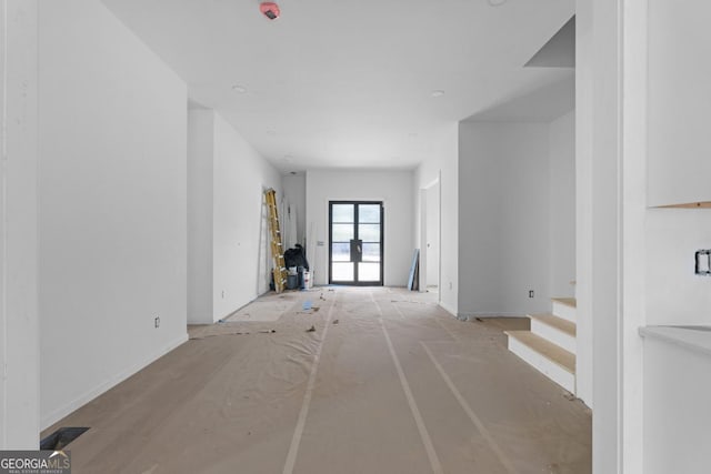 unfurnished living room with french doors