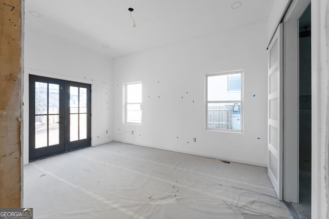 unfurnished room featuring french doors