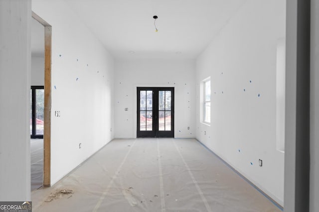 interior space featuring a towering ceiling and french doors