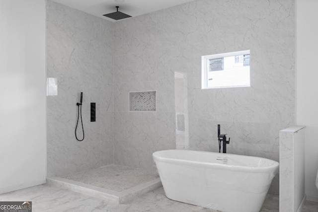 bathroom featuring independent shower and bath