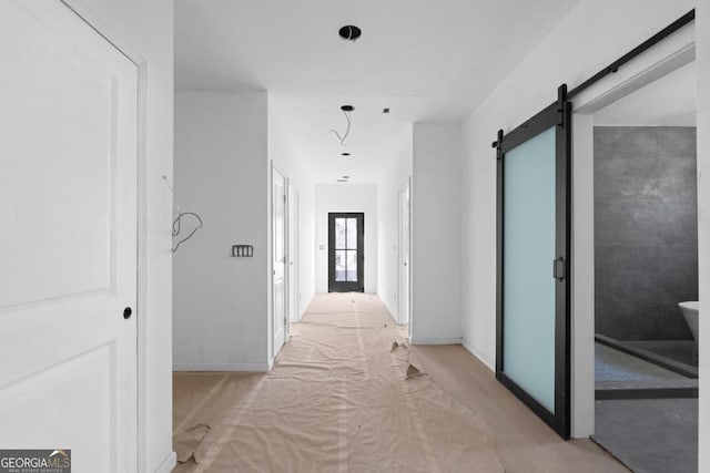 corridor featuring a barn door