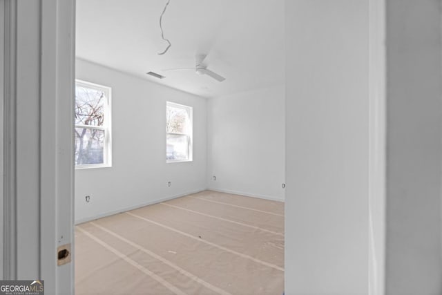 unfurnished room with ceiling fan