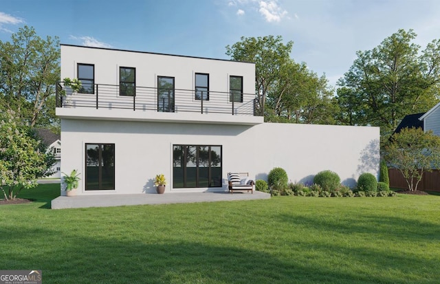 back of house featuring a lawn, a balcony, and a patio