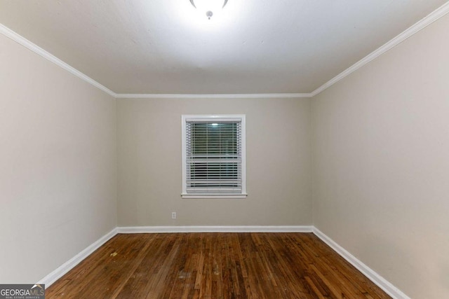 empty room featuring crown molding and dark hardwood / wood-style floors