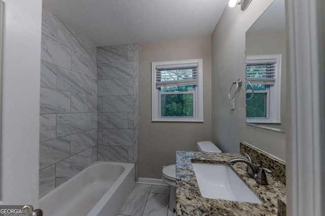 full bathroom with toilet, vanity, and tiled shower / bath combo