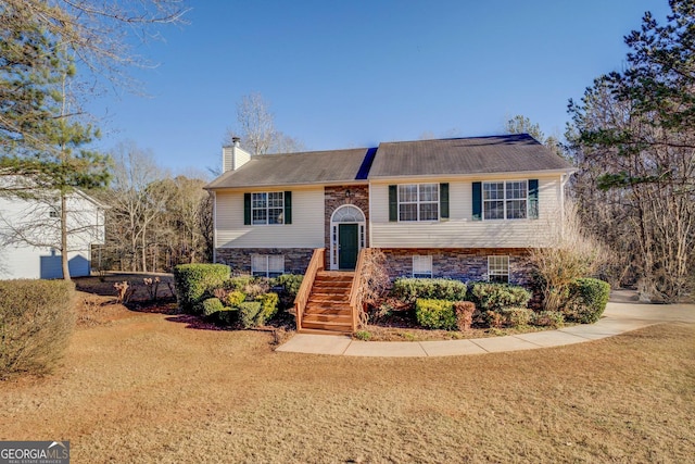 raised ranch with a front yard