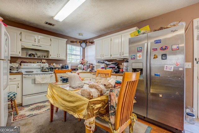 kitchen featuring white cabinetry, white electric range oven, stainless steel fridge with ice dispenser, and a textured ceiling