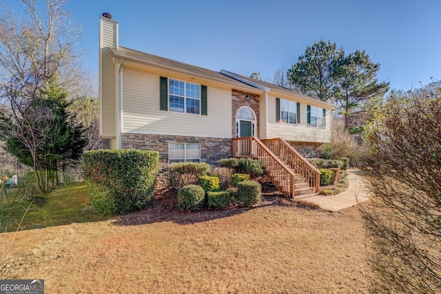 bi-level home with a front lawn