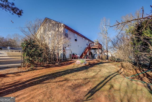 view of home's exterior featuring a deck and a yard