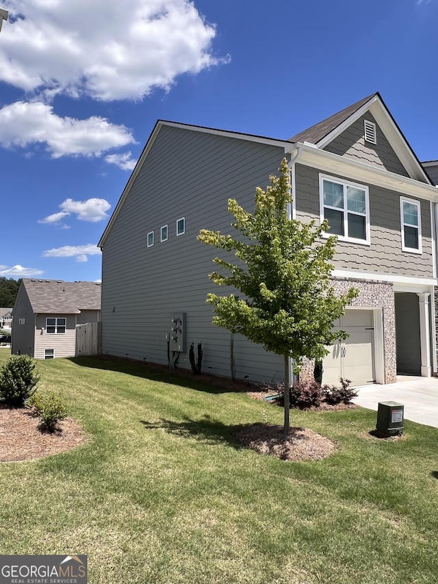 view of home's exterior featuring a yard and a garage