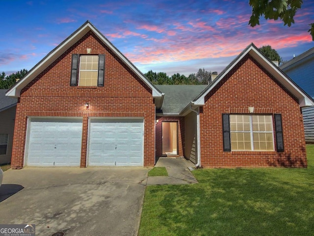 view of property featuring a garage and a yard