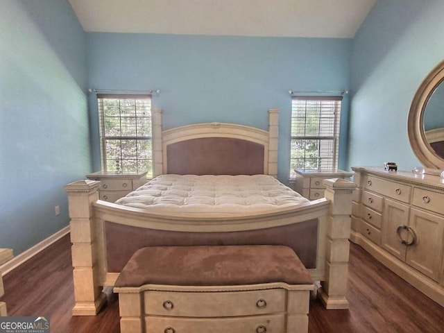 bedroom with dark hardwood / wood-style flooring