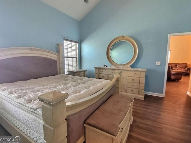 bedroom featuring dark hardwood / wood-style flooring and lofted ceiling