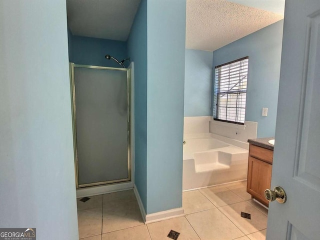 bathroom featuring vanity, independent shower and bath, tile patterned floors, and a textured ceiling