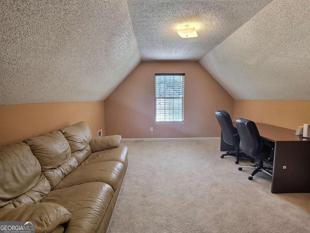 office area with light colored carpet, a textured ceiling, and vaulted ceiling