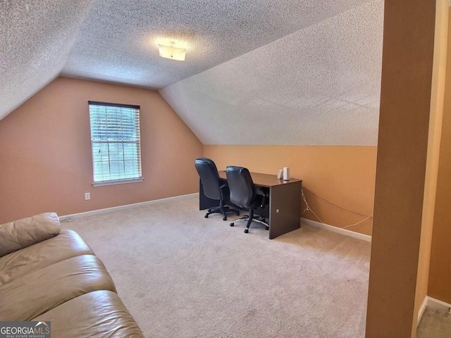 carpeted office space with lofted ceiling and a textured ceiling