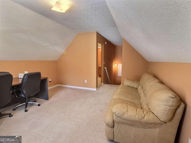 office space with a textured ceiling, carpet, and lofted ceiling