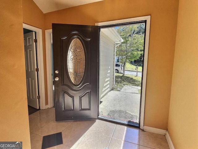 tiled foyer entrance with lofted ceiling