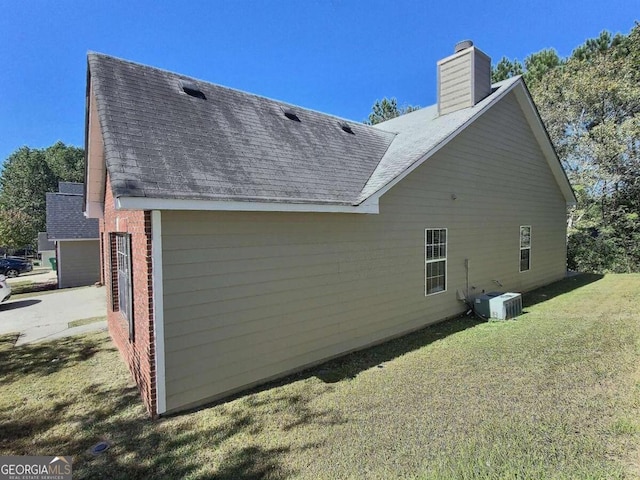 view of property exterior featuring a garage and a lawn