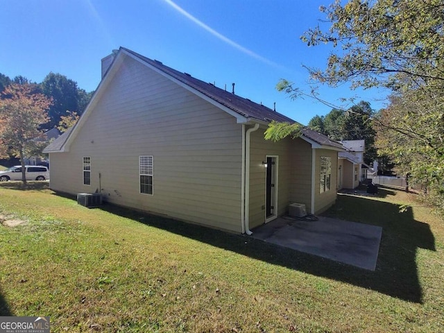 view of property exterior featuring a lawn, cooling unit, and a patio area